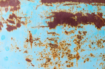 Cracked blue paint on the metal