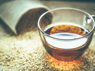 Sesame oil in one gleass on wood table.