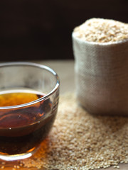Sesame oil in one gleass on wood table.
