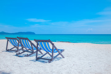 Beach chairs with sea and bright sky