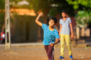 Rural Indian Child Playing Cricket