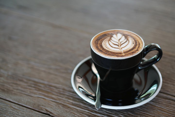 Hot Mocha - A Cup of Coffee with Beautiful latte art on wooden table background and copy space, Perfect for breakfast time.