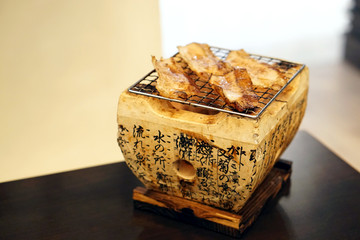 Roasted pork cheek - Grilling sliced kurobuta pork over hot charcoal stove, Japanese barbecue style called Yakiniku.