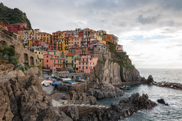 Fototapeta na wymiar Manarola in the Cinque Terre, Italy. Beautiful seaside town and fishermen, a popular tourist destination for sea holidays and tracking in unspoiled nature.