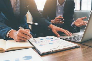 Business concept. Business people discussing the charts and graphs showing the results of their...