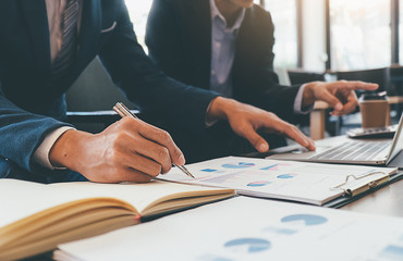 Business concept. Business people discussing the charts and graphs showing the results of their successful teamwork.