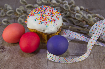 colorful Easter eggs with willow twig and Easter cake
