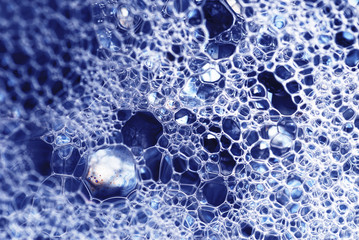 Water surface with bubbles. Bubbles in abstract blue.