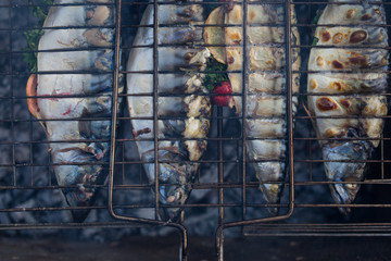 Fragrant mackerel grilled with lemon and spices in the smoke from fire