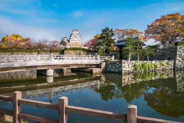 Autumn reflections in water at Sakuramon-bashi bridge over the inner moat at the entry gate to Himeji Castle in Japan.
