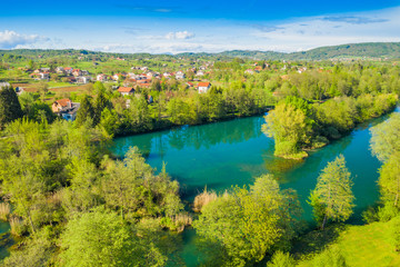 Croatia, green countryside, Mreznica river from air, panoramic view of Belavici village, waterfalls in spring, popular tourist destination