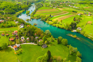 Croatia, green countryside, Mreznica river from air, panoramic view of Belavici village, waterfalls in spring, popular tourist destination
