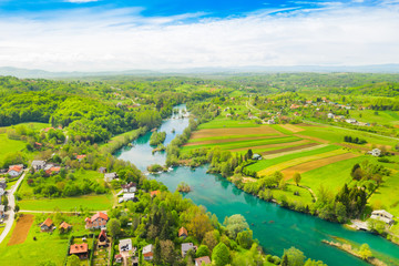 Fototapeta na wymiar Croatia, green countryside, Mreznica river from air, panoramic view of Belavici village, waterfalls in spring, popular tourist destination