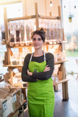 Portrait of a young woman arms crossed, owner of her food store. 