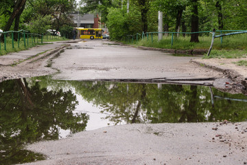 Very large, deep pit with water for the entire width of the road after the sewer repair. People...