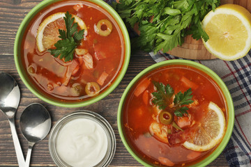 Two bowls with traditional Russian soup solyanka