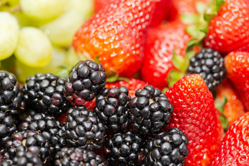 Colorful assorted mix of fresh organic blackberries, strawberries and grapes.