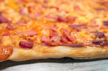 The End Crust, Edge or Lip of a Cooked Pizza on a Sheet Pan.
