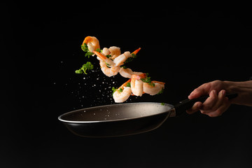 Sea food, cooking shrimp with herbs, on a dark background, horizontal photo, healthy and wholesome...