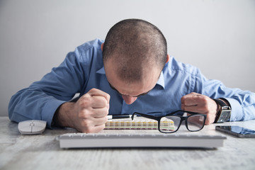 Businessman hits the table with his fists. Concept of anger