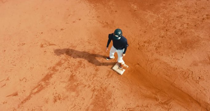 OVERHEAD CRANE Base runner attempts to touch a base during a baseball game. 4K UHD 60 FPS SLO MO RAW