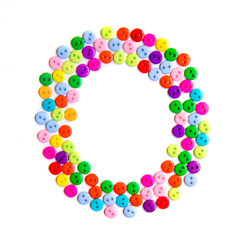 Letter O of the English alphabet made of multi-colored buttons