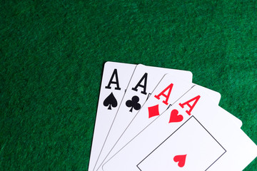 Set of four aces on the green table