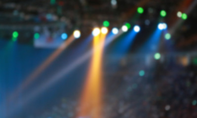 Blurred Concert light with colored spotlights and smoke.