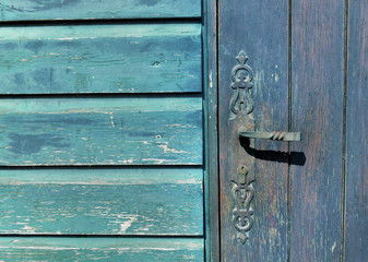 close on  lock handle of a  blue wooden door on blue wooden wall