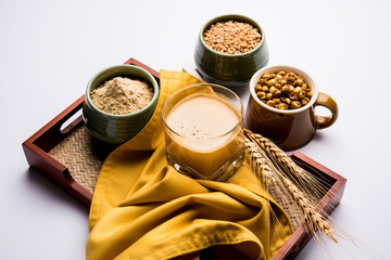 Obraz na płótnie Canvas Sattu sharbat is a cooling sweet drink made in summer with roasted black chickpea flour, barley, suger, salt & water. served in a glass. selective focus