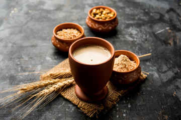 Sattu sharbat is a cooling sweet drink made in summer with roasted black chickpea flour, barley, suger, salt & water. served in a glass. selective focus