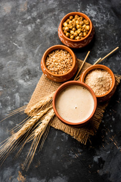 Sattu sharbat is a cooling sweet drink made in summer with roasted black chickpea flour, barley, suger, salt & water. served in a glass. selective focus