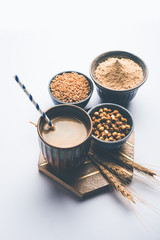 Sattu sharbat is a cooling sweet drink made in summer with roasted black chickpea flour, barley, suger, salt & water. served in a glass. selective focus