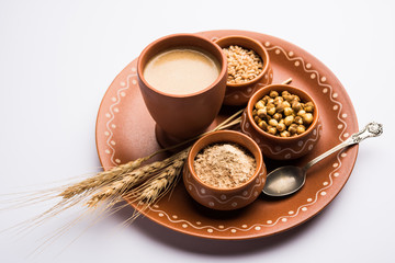 Sattu sharbat is a cooling sweet drink made in summer with roasted black chickpea flour, barley, suger, salt & water. served in a glass. selective focus