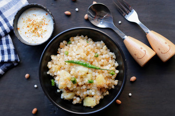Indian dish made out of Sago called Sabudana khichdi, Usually eaten during fasting days, served with curd in a bowl	