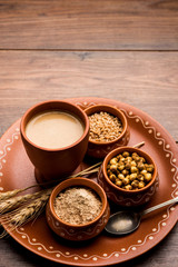 Sattu sharbat is a cooling sweet drink made in summer with roasted black chickpea flour, barley, suger, salt & water. served in a glass. selective focus