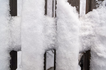 Fence of snow covered boards