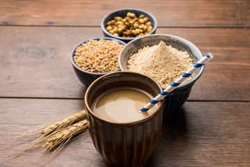 Sattu sharbat is a cooling sweet drink made in summer with roasted black chickpea flour, barley, suger, salt & water. served in a glass. selective focus