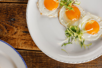 Fried egg on a wooden background. Isolated. View from above.