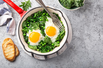 fried eggs with kale, spinach and green peas for breakfast