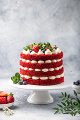 festive  Red Velvet cake on white cake stand