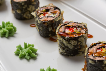 Smoked salmon sushi roll served on a plate
