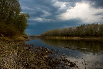 heavy lead clouds gathered over the Ural river before sunset