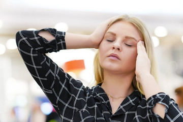 Woman suffering from headache migraine pain. Health problem, stress and depression. Female holds...