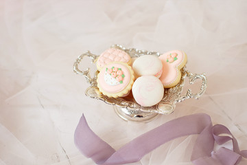 Fototapeta premium Vintage vase and gingerbread in pale pink colors and macaroon, wedding or festive concept