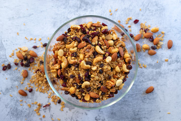  homemade granola made from oatmeal, raisins, honey,  blueberries, cranberry, flax, almond, macadamia, cashew, pecan, freshly baked .