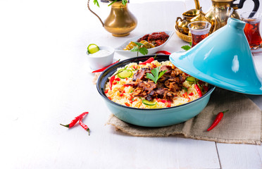 Tajin with couscous, vegetables and meat on white background