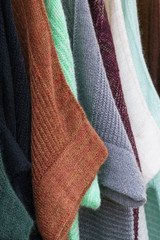 Details of several pieces of soft natural colored knitwear