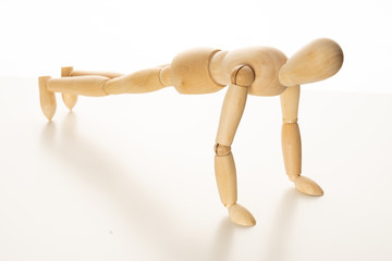 Wooden Mannequin Doing Push-Up Exercise