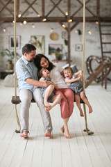 Obraz na płótnie Canvas Ordinary dark-haired family with two sons at home